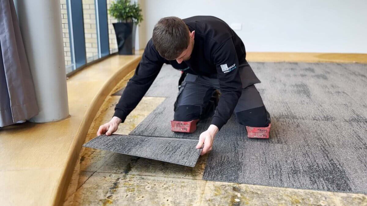 One of our fitters laying down a Carpet tile for CLM Church in Coventry