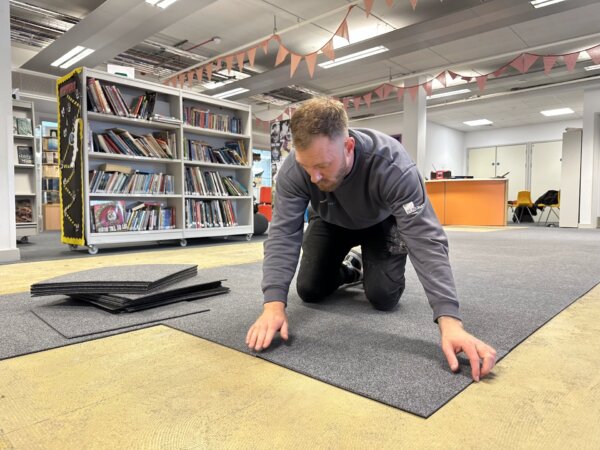 Carpet tiles being fitted at a library of a Secondary School